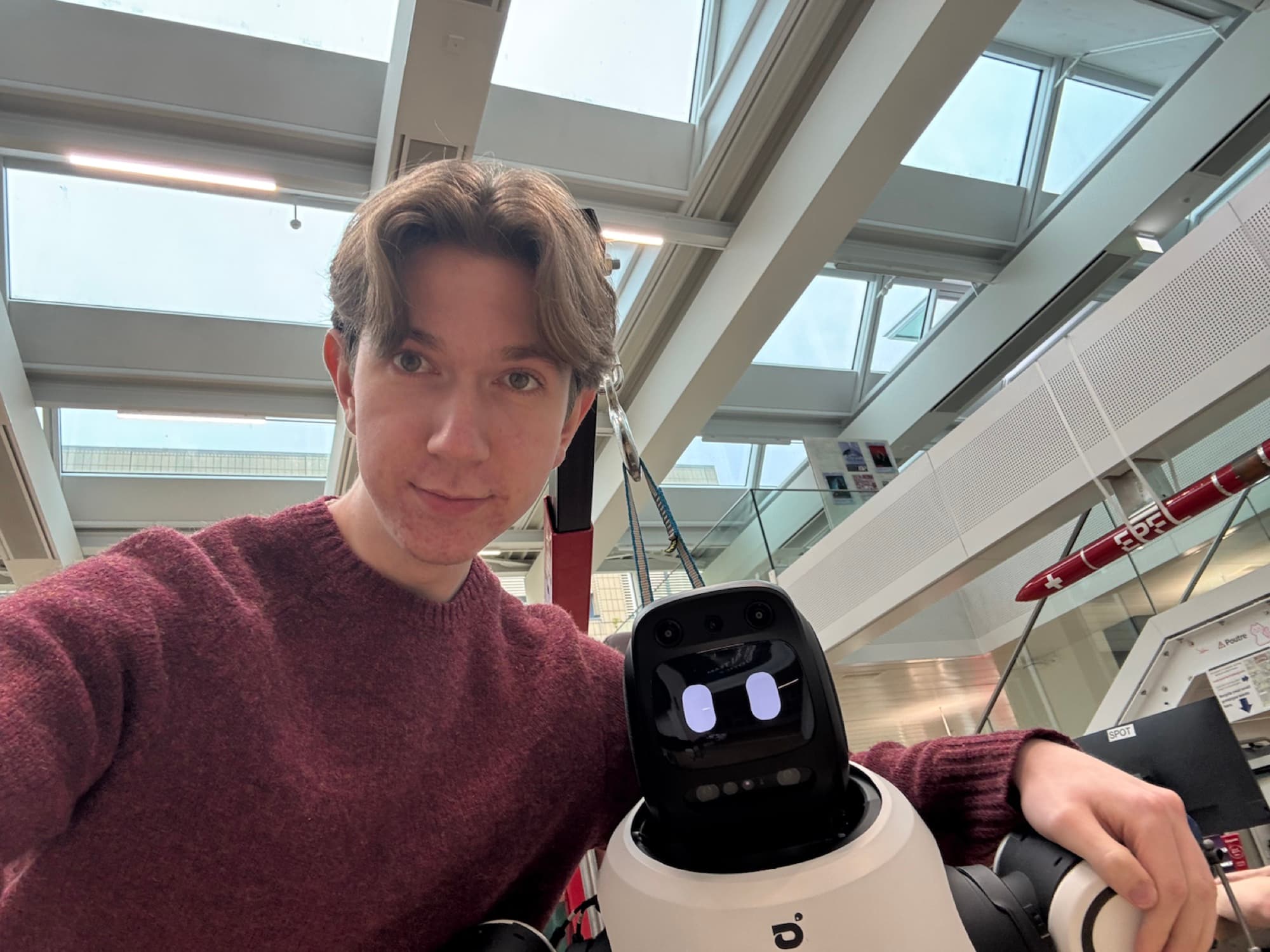 Sebastian beside the AgiBot X2 during Robohack 2026